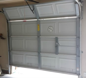 How do I fix a garage door that opens halfway?
