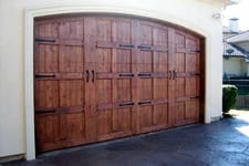 stained wood garage door with hardware
